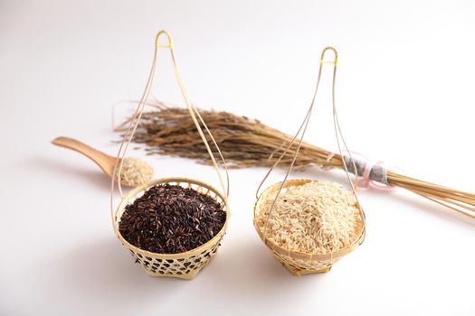 Organic raw brown rice and riceberry rice on Wicker basket in close up