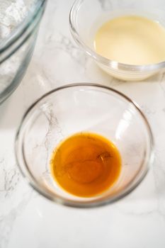 Measured ingredients in glass mixing bowls to make eggnog buttercream frosting.
