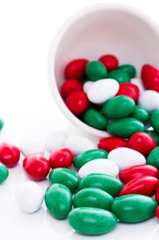 Colorful red, green and white candies on white background.