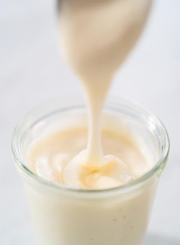 Cream cheese glaze in small glass jat.
