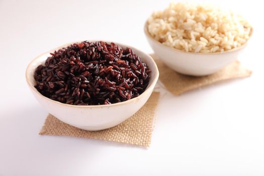 Organic boiled brown rice on bowl isolated in white background