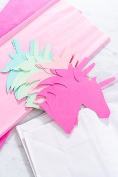 Materials to make unicorn Birthday party favor bags for a little girl's Birthday party.