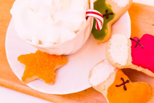 Colorful Christmas sugar cookies with hot chocolate.
