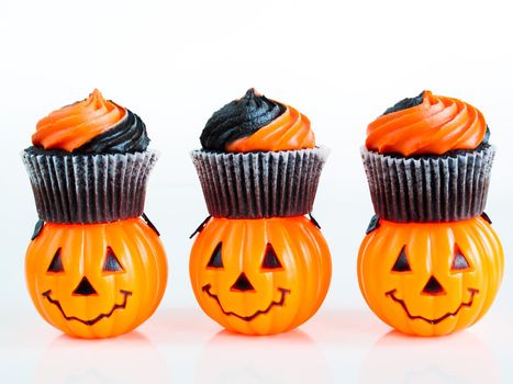 Halloween cupcakes decorated with black and orange swirled icing.