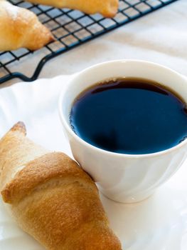 Eating small croissants for breakfast.