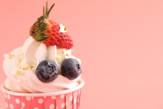 Fruits cupcake isolated in pink background