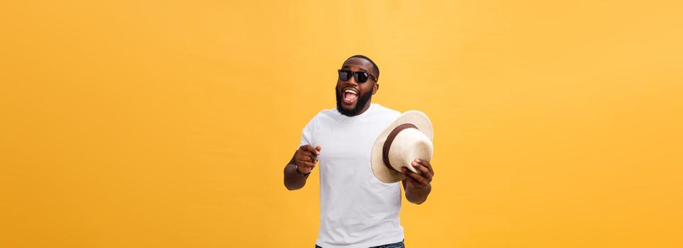 Young black man top dancing isolated on a yellow background