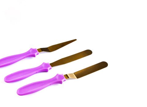 Professional Offset Spatula Set for icing large cakes quickly. starter kit for decorating a cake. Confectioner's tools isolate on white . pastry spatulas. High quality photo