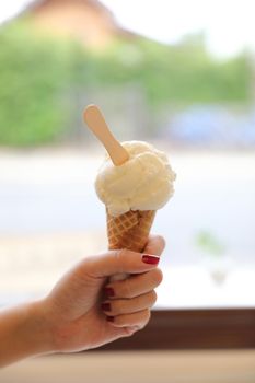 Woman hand with ice cream in close up