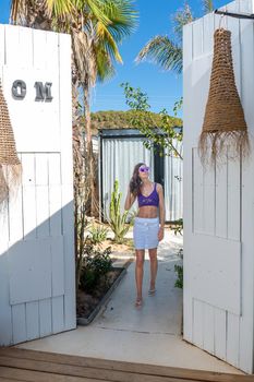 Brunette woman with white skirt posing in a boutique hotel