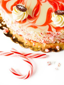 Traditional Christmas White Chocolate Peppermint Cheesecake on white background.