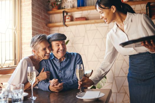 Love, couple elderly and celebrate marriage with date and wine at restaurant, happy, smile or relax together. Loving, senior man and woman with champagne for celebration of retirement or anniversary.