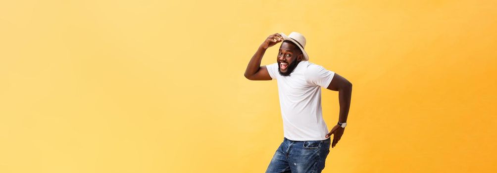 Full length of handsome young black man jumping against yellow background