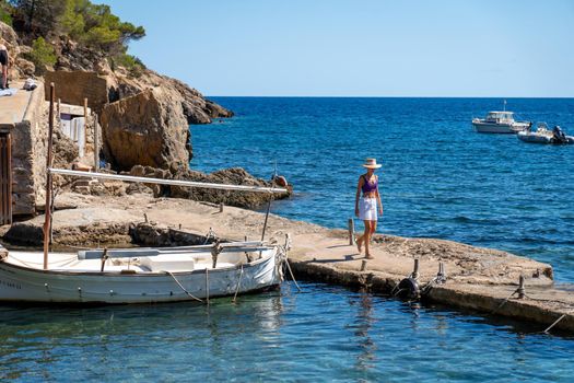 Woman walking on a pier in the mediterranean sea