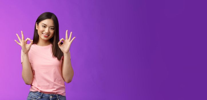 Friendly joyful good-looking stylish asian girl brunette show okay accept sign, smiling delighted feel fine, give recommendation, approve nice choice, stand purple background satisfied.