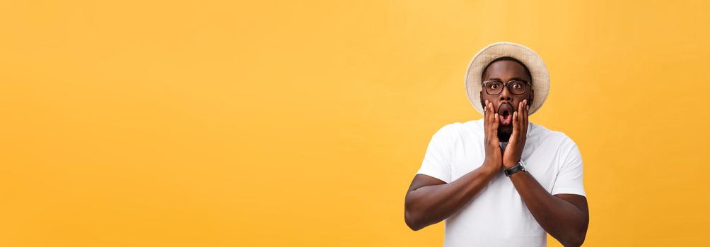 Headshot of goofy surprised bug-eyed young dark-skinned man student wearing casual white t-shirt staring at camera with shocked look