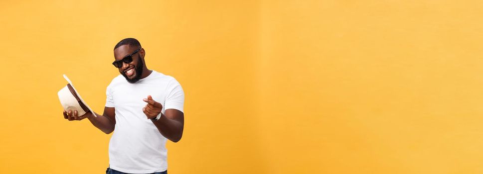 Young black man top dancing isolated on a yellow background