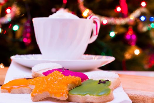 Colorful Christmas sugar cookies with hot chocolate.