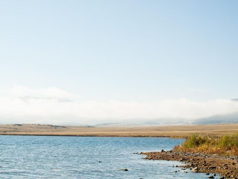 Early morning at the lake with fog in early Fall.