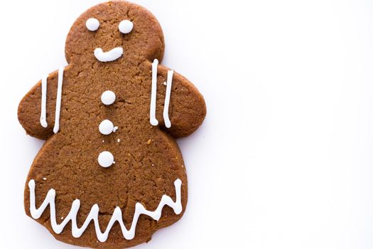 Homemade gingerbread cookies decorated with white icing on white background.