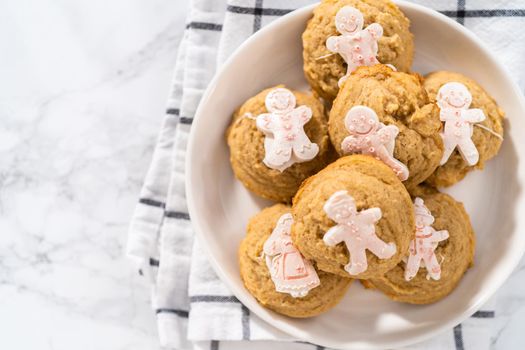 Eggnog cookies with a chocolate gingerbread man on a white plate.