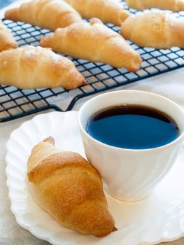 Eating small croissants for breakfast.