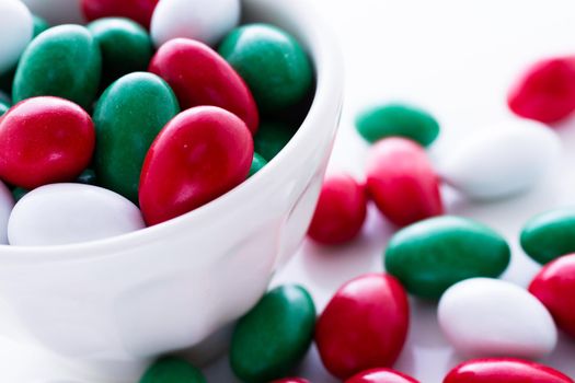 Colorful red, green and white candies on white background.