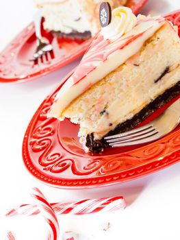 Traditional Christmas White Chocolate Peppermint Cheesecake on white background.