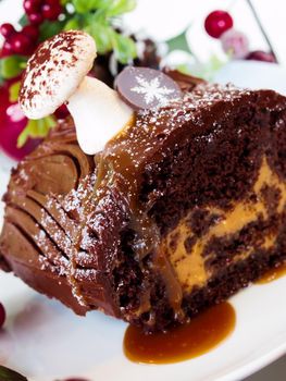 Traditional Christmas Yule Log cake decorated with marzipan mushrooms.