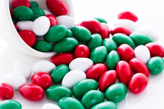 Colorful red, green and white candies on white background.