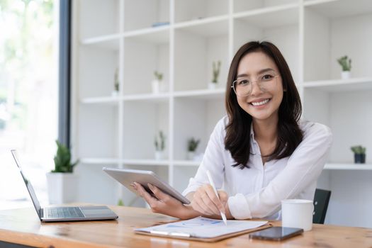 Smart asian business woman smiling at office space. real estate, lawyer, non-profit, marketing.