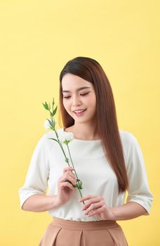Close up portrait of an attractive young woman holding flower