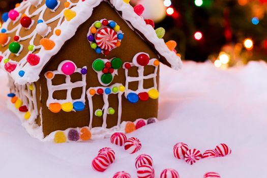 Gingerbread house with round peppermint candies.