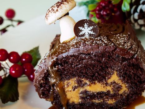 Traditional Christmas Yule Log cake decorated with marzipan mushrooms.