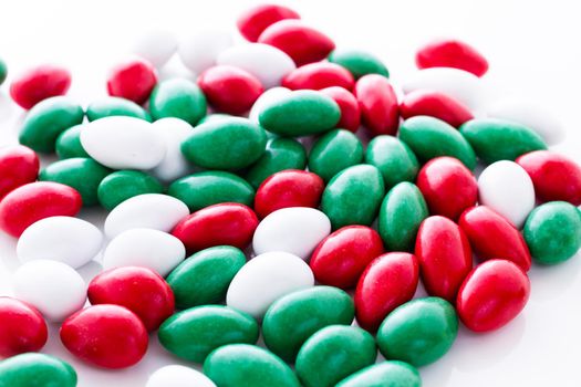 Colorful red, green and white candies on white background.