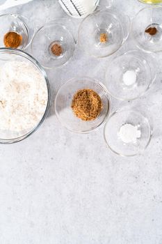 Ingredients in a glass mixing bowls to make pumpkin pancakes.