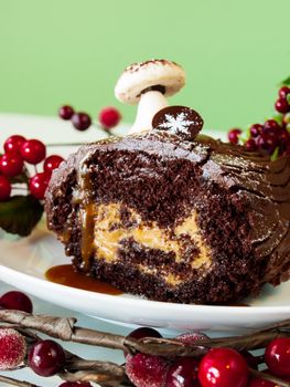 Traditional Christmas Yule Log cake decorated with marzipan mushrooms.