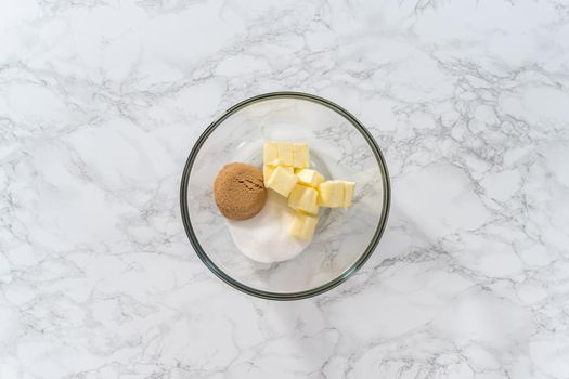 Flat lay. Mixing ingredients with a hand mixer to bake eggnog cookies with a chocolate gingerbread man.