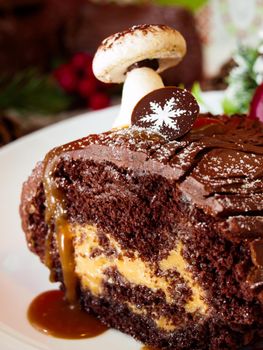 Traditional Christmas Yule Log cake decorated with marzipan mushrooms.
