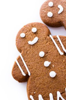 Homemade gingerbread cookies decorated with white icing on white background.
