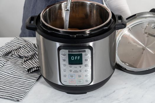 Pressure Cooker Baked Potatoes. Poking cooked potatoes with a knife to prepare baked potatoes.