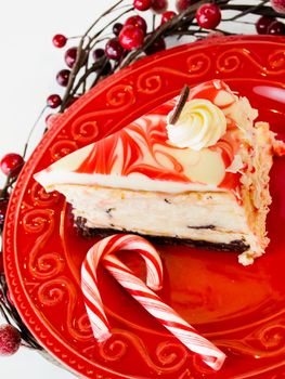 Traditional Christmas White Chocolate Peppermint Cheesecake on white background.