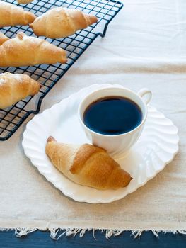 Eating small croissants for breakfast.