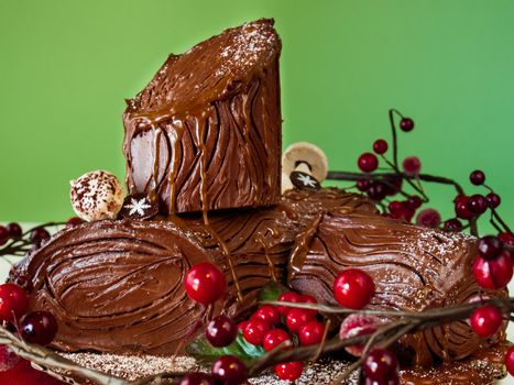Traditional Christmas Yule Log cake decorated with marzipan mushrooms.