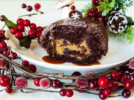 Traditional Christmas Yule Log cake decorated with marzipan mushrooms.