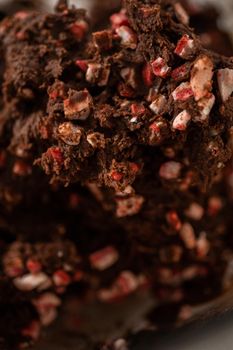 Folding in peppermint chocolate chips into a chocolate cookie dough to bake chocolate cookies with peppermint chips.