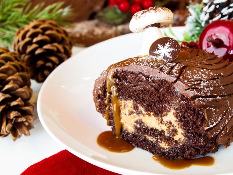 Traditional Christmas Yule Log cake decorated with marzipan mushrooms.