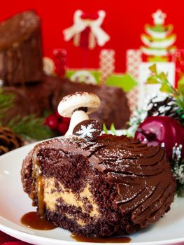 Traditional Christmas Yule Log cake decorated with marzipan mushrooms.