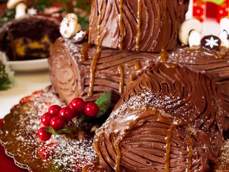 Traditional Christmas Yule Log cake decorated with marzipan mushrooms.