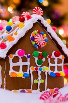 Gingerbread house with round peppermint candies.